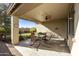 Covered patio with rocking chairs and a view of the backyard at 10245 E Texas Ave, Mesa, AZ 85212