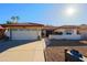 Single-story home with tile roof, attached garage, and desert landscaping at 10417 E Watford Way, Sun Lakes, AZ 85248