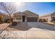 One-story house with a brown garage door and desert landscaping at 1241 E Paul Dr, Casa Grande, AZ 85122