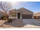 Tan house with a two-car garage and small front yard at 1241 E Paul Dr, Casa Grande, AZ 85122