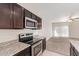 Kitchen features dark wood cabinets, granite countertops and a stove at 1241 E Paul Dr, Casa Grande, AZ 85122