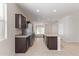 Kitchen boasts dark cabinetry, granite counters & stainless steel appliances at 1241 E Paul Dr, Casa Grande, AZ 85122