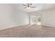 Living area with carpeted floors and a sliding glass door to patio at 1241 E Paul Dr, Casa Grande, AZ 85122
