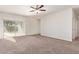Bright and airy living room featuring carpet and a sliding glass door at 1241 E Paul Dr, Casa Grande, AZ 85122
