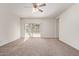 Spacious living room with neutral walls, carpet, and a sliding glass door at 1241 E Paul Dr, Casa Grande, AZ 85122