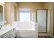 Bathroom with shower, bathtub and window at 1480 E Harrison St, Gilbert, AZ 85295