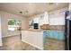 Spacious kitchen with light teal cabinets and stainless steel appliances at 1480 E Harrison St, Gilbert, AZ 85295