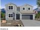 Two-story house with gray exterior, three windows on the second floor and two on the first floor, a two-car garage, and a small front yard at 2112 W Stanton Ave, Apache Junction, AZ 85120