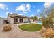 Landscaped backyard with grassy area, pool, and patio at 4494 E Brae Voe Way, San Tan Valley, AZ 85140