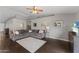 Spacious living room with hardwood floors and a gray sectional sofa at 4494 E Brae Voe Way, San Tan Valley, AZ 85140
