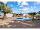 Backyard oasis featuring a sparkling pool and palm trees at 5827 E Beck Ln, Scottsdale, AZ 85254