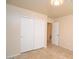 Bright bedroom with tile flooring and double-door closet at 6709 W Luke Ave, Glendale, AZ 85303