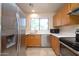 Bright kitchen featuring stainless steel appliances and light wood cabinets at 6709 W Luke Ave, Glendale, AZ 85303