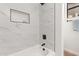 Modern bathroom with marble tile and a bathtub at 6914 E Pearl St, Mesa, AZ 85207