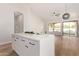 White kitchen island with view into adjacent living area at 6914 E Pearl St, Mesa, AZ 85207