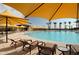 Community pool with lounge chairs and yellow umbrellas at 7674 W Cactus Wren Way, Florence, AZ 85132
