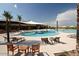 Community pool with lounge chairs and shade structures at 7674 W Cactus Wren Way, Florence, AZ 85132