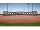 Well-lit softball field with covered dugouts at 7674 W Cactus Wren Way, Florence, AZ 85132