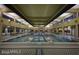 Large indoor swimming pool with tiled floor and large windows at 7682 W Mockingbird Way, Florence, AZ 85132