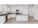 Modern kitchen with white cabinets, granite counters and island at 8391 W Mantle Way, Florence, AZ 85132