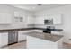 Modern kitchen with white cabinets, granite countertops, and island at 8391 W Mantle Way, Florence, AZ 85132