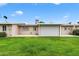 Backyard view of the property, showing patio and grass at 10404 W Audrey Dr, Sun City, AZ 85351