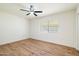 Spacious bedroom with hardwood floors, window, and ceiling fan at 10404 W Audrey Dr, Sun City, AZ 85351