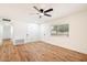 Bright bedroom with hardwood floors, ceiling fan, and large window at 10404 W Audrey Dr, Sun City, AZ 85351