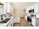 Updated kitchen with white cabinets, stainless steel appliances, and a large island at 10404 W Audrey Dr, Sun City, AZ 85351