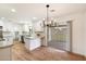 Modern kitchen with white cabinets, an island, and access to a patio at 10404 W Audrey Dr, Sun City, AZ 85351