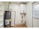 Laundry area with shelving and water heater at 10404 W Audrey Dr, Sun City, AZ 85351