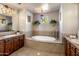 Spa-like bathroom with a large soaking tub and double vanity at 10821 E Tusayan Trl, Scottsdale, AZ 85255