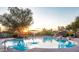Community pool with lounge chairs and sunset view at 10821 E Tusayan Trl, Scottsdale, AZ 85255