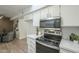 Modern kitchen with white cabinets, stainless steel appliances, and quartz countertops at 13082 N 100Th Ave, Sun City, AZ 85351