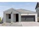 Charming craftsman style home with gray exterior, dark garage door, and a covered porch at 2334 E Levi Dr, Phoenix, AZ 85040