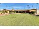 Building exterior with grassy yard and palm trees at 2601 E Allred Ave # 20, Mesa, AZ 85204