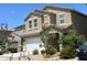 Two-story house with a white garage door and landscaping at 35262 W San Ildefanso Ave, Maricopa, AZ 85138