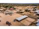 Aerial view showing a house with a large yard, outbuildings, and a covered structure at 37032 N 12Th St, Phoenix, AZ 85086