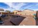 Under-construction backyard featuring a large deck and landscaping at 38234 W La Paz St, Maricopa, AZ 85138