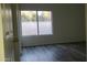 Simple bedroom with grey wood-look floors and a large window at 4044 W Shannon St, Chandler, AZ 85226