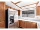 Kitchen with wood cabinets and stainless steel refrigerator at 509 E Ironwood Dr, Phoenix, AZ 85020