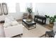 Living room with beige sofa, coffee table, and decorative plants at 5720 S Daisy Patch Pl, Phoenix, AZ 85040