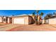 Front view of a single-story house with a garage and desert landscaping at 7318 W Greer Ave, Peoria, AZ 85345