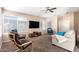 Bright living room featuring a TV, comfortable seating, and large windows at 7318 W Greer Ave, Peoria, AZ 85345