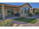 Landscaped backyard with artificial turf, a patio, and a built-in grill at 7320 W Stony Quail Way, Florence, AZ 85132