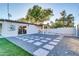 Backyard with patio, gravel landscaping, and artificial turf at 7538 E Garfield St, Scottsdale, AZ 85257