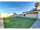 Large backyard, artificial turf, covered patio, and gravel at 7538 E Garfield St, Scottsdale, AZ 85257