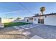 Backyard with patio, gravel landscaping, and artificial turf at 7538 E Garfield St, Scottsdale, AZ 85257