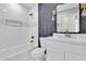 Updated bathroom with white vanity and hexagon tile accents at 7538 E Garfield St, Scottsdale, AZ 85257
