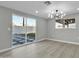 Dining area with sliding glass doors and modern chandelier at 7538 E Garfield St, Scottsdale, AZ 85257
